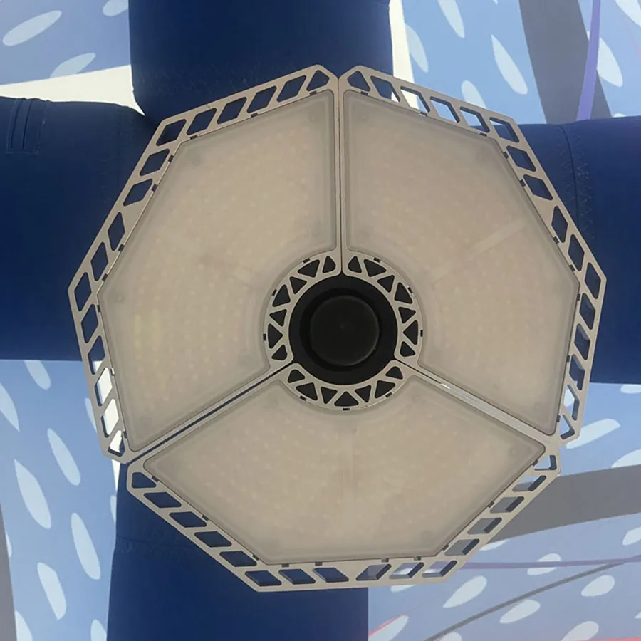 Innenansicht eines Dome-Zeltes mit blauen Luftbögen, bedruckter Dachfläche und LED-Lampe